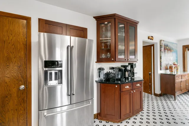 a kitchen with stainless steel appliances granite countertop a refrigerator and a stove