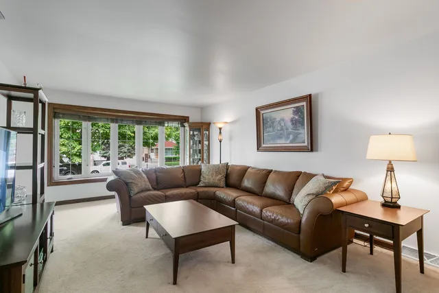a living room with furniture and a lamp