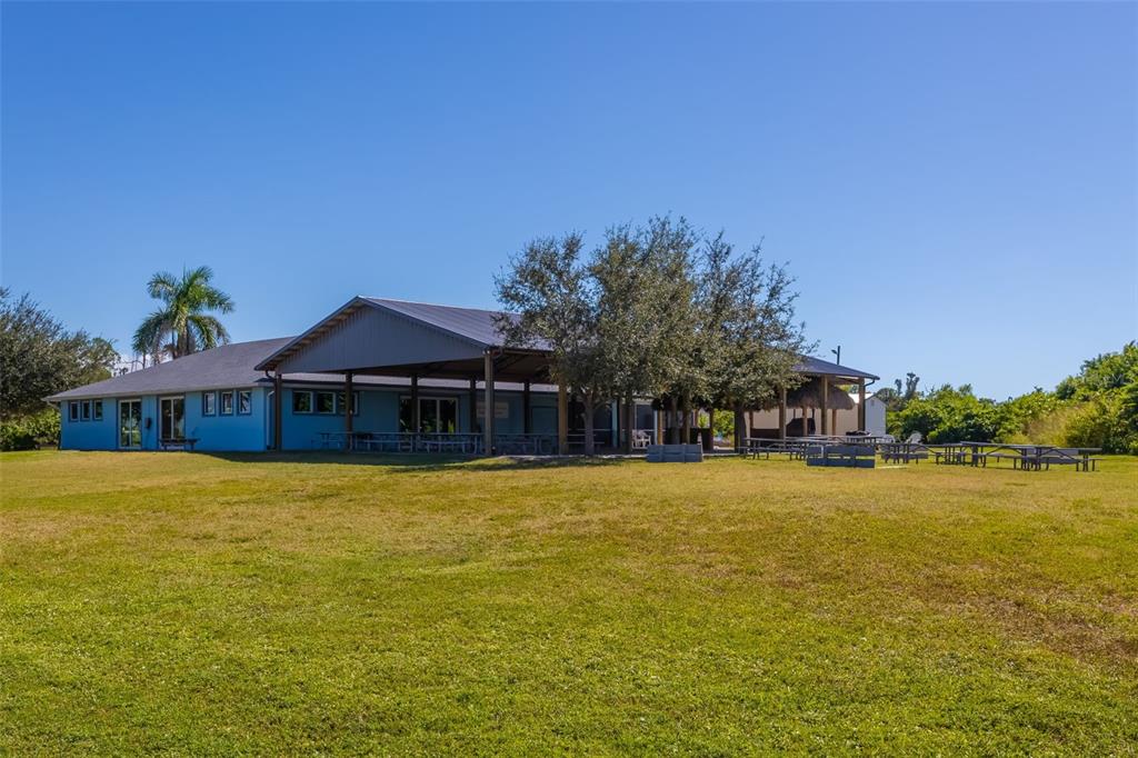 14265 Imlay Avenue Port Charlotte, FL 33981 - Photo 12 of 22 a front view of house with yard and trees in the background
