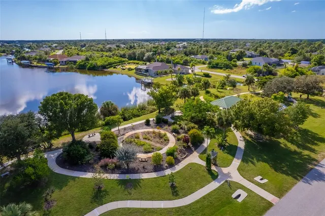 a view of a lake with a yard and outdoor seating