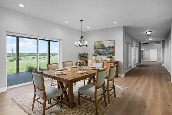 a dining room with furniture window and wooden floor