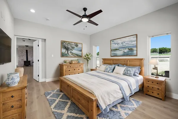 a bedroom with a bed and a tv on the dresser