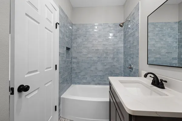 a bathroom with a sink a shower and a bathtub