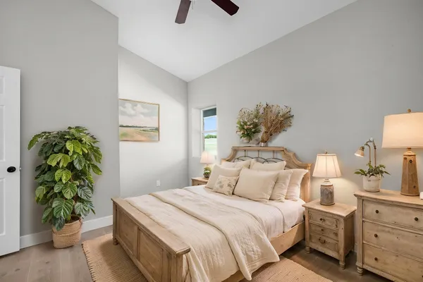 a bedroom with a bed and a potted plant