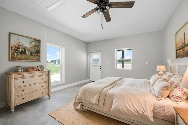 a bedroom with a bed and a painting on the wall