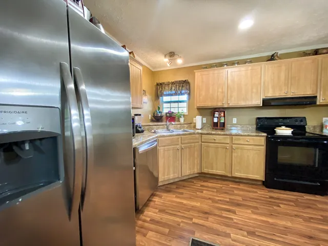 a kitchen with cabinets and stainless steel appliances
