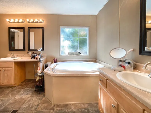 a bathroom with a granite countertop sink a toilet and mirror