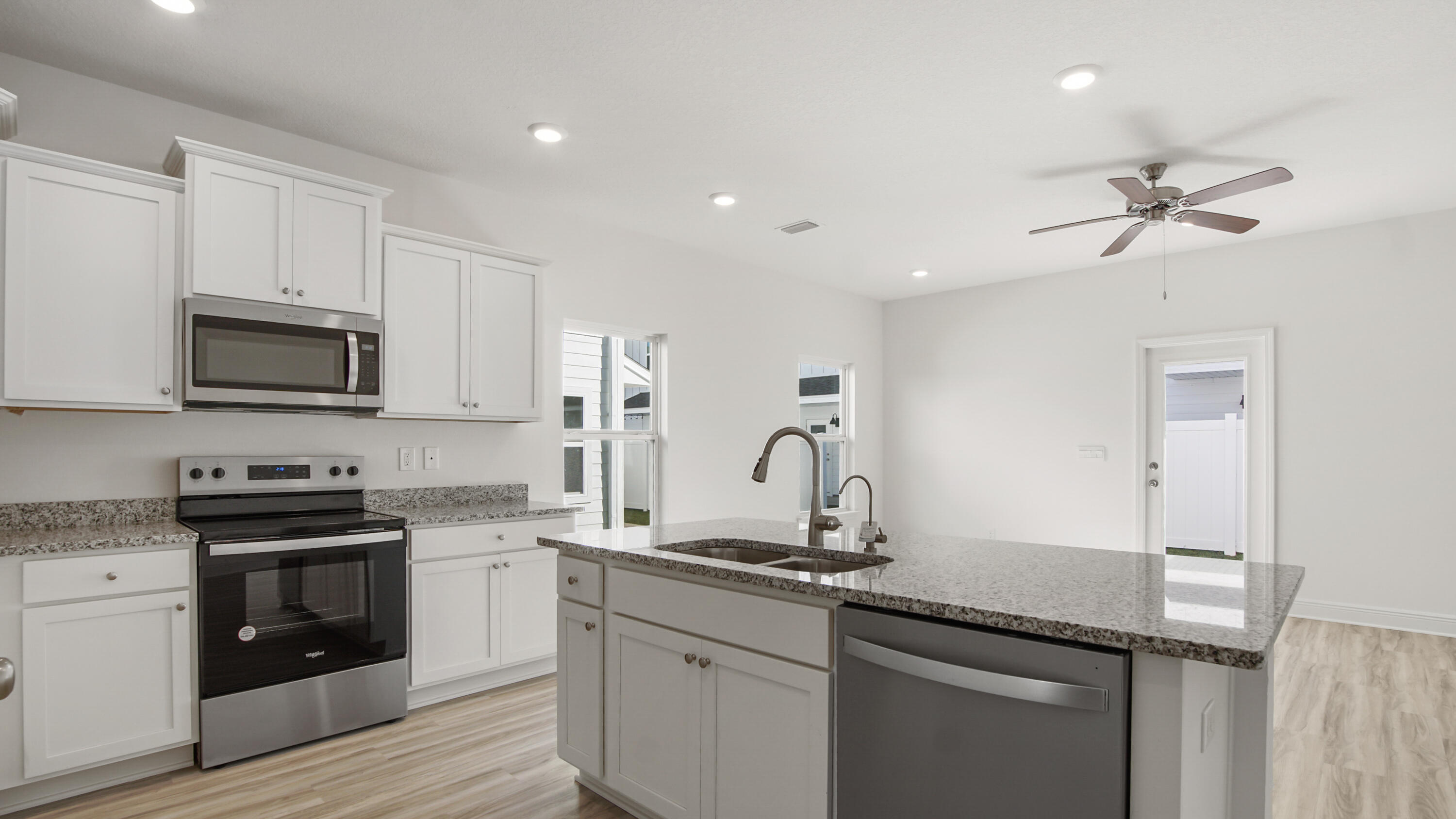 73 Mamba Lane Santa Rosa Beach, FL 32459 - Photo 8 of 35 a kitchen with appliances a sink cabinets and wooden floor