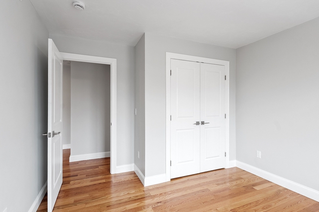 10 Windsor Street Worcester, MA 01605 - Photo 21 of 26 a view of an empty room with wooden floor