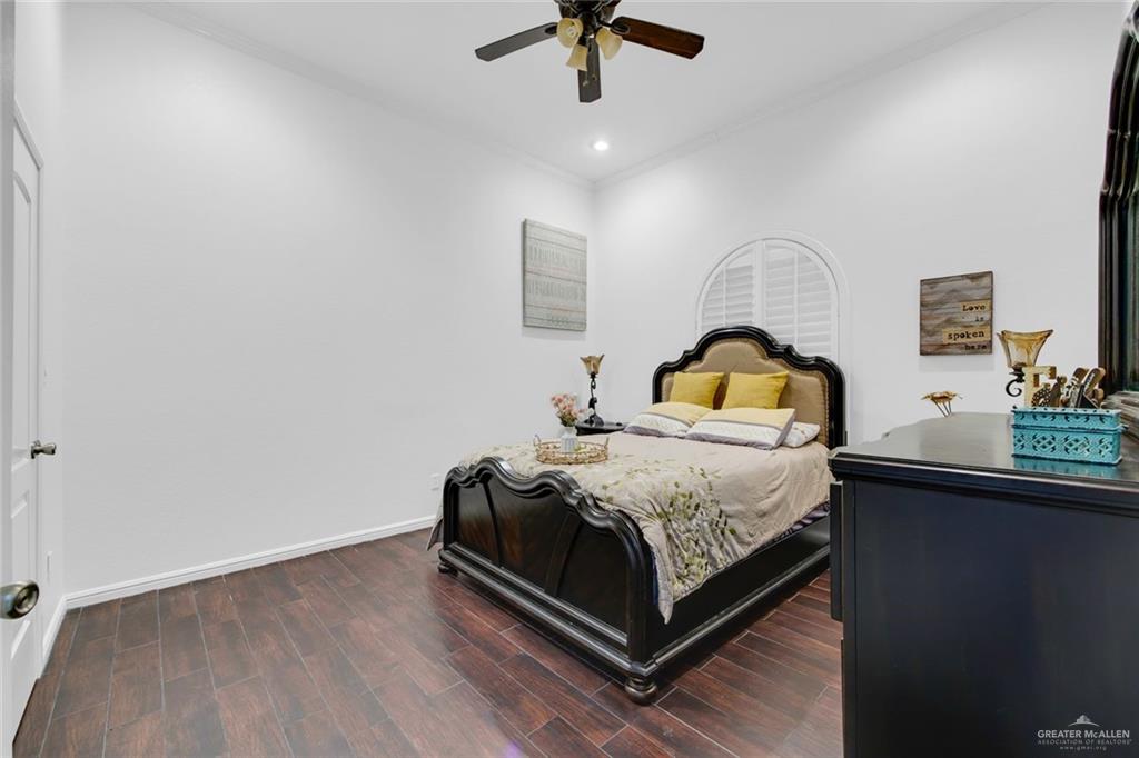 2405 West Rhin Drive Edinburg, TX 78539 - Photo 17 of 26 a bedroom with a bed a dresser and potted plants on the dresser