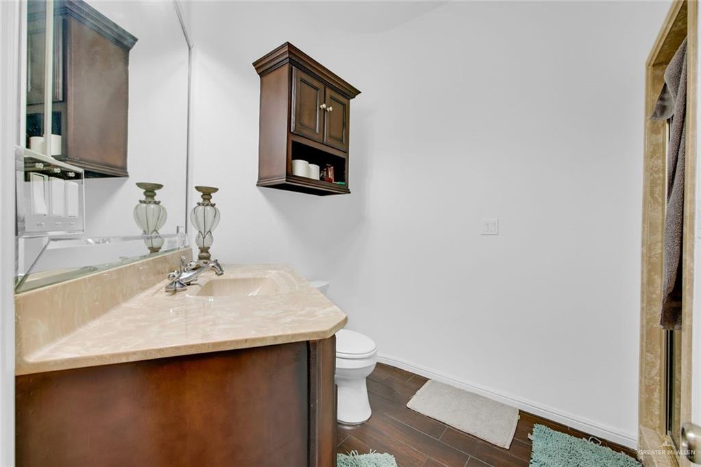 2405 West Rhin Drive Edinburg, TX 78539 - Photo 18 of 26 a bathroom with a sink mirror and toilet