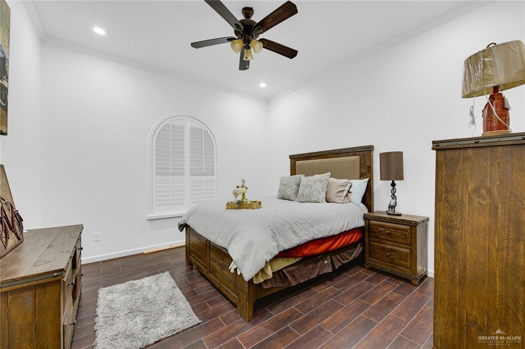 2405 West Rhin Drive Edinburg, TX 78539 - Photo 19 of 26 a spacious bedroom with a bed and a chandelier