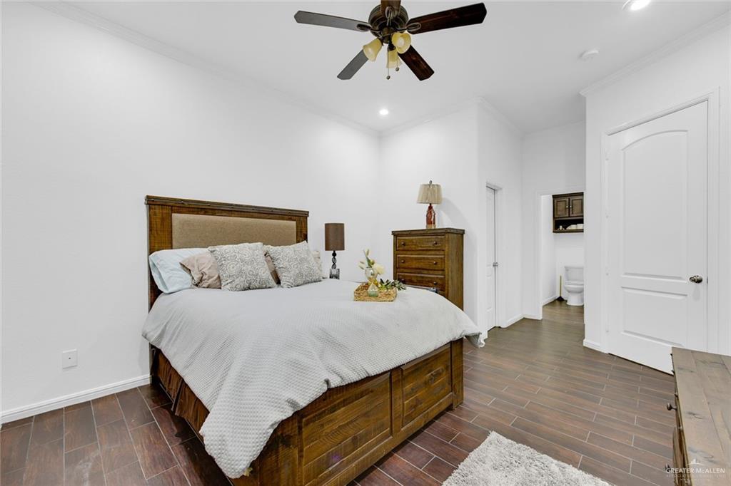 2405 West Rhin Drive Edinburg, TX 78539 - Photo 20 of 26 a bed room with a bed and a chandelier