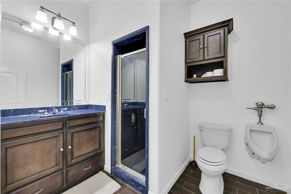 2405 West Rhin Drive Edinburg, TX 78539 - Photo 21 of 26 a bathroom with a toilet a sink and mirror