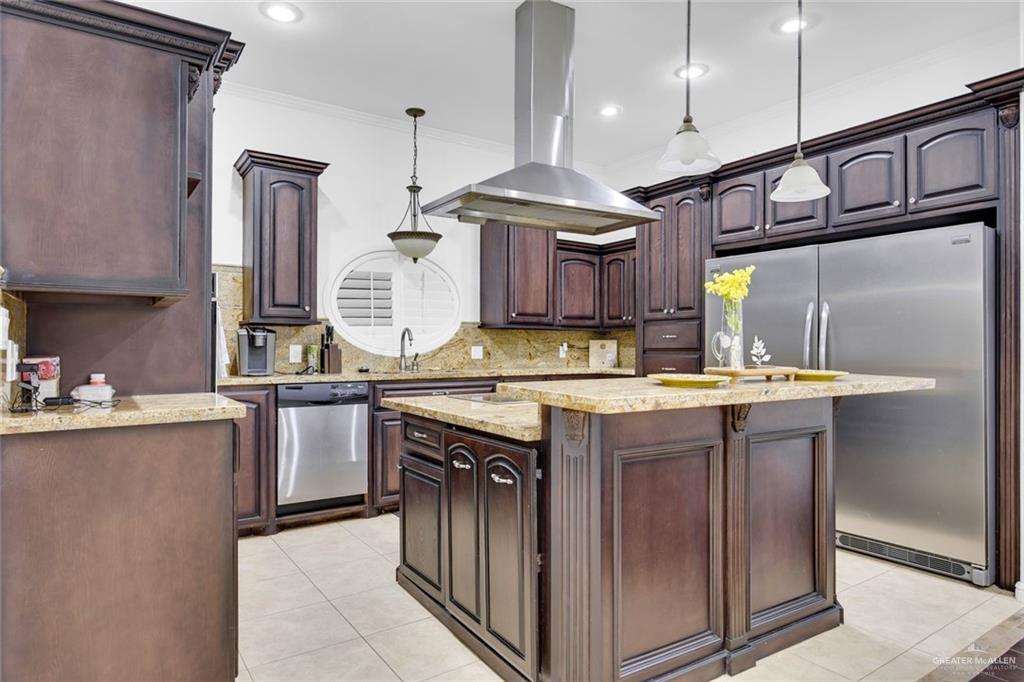 2405 West Rhin Drive Edinburg, TX 78539 - Photo 6 of 26 a kitchen with stainless steel appliances granite countertop a sink a stove and a wooden floors