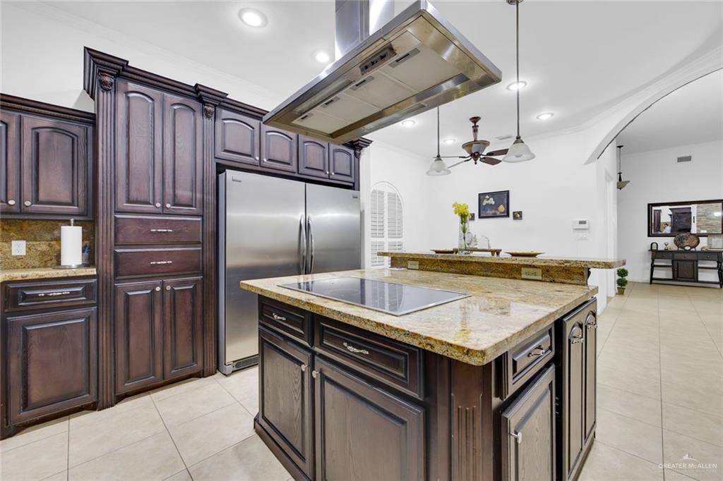 2405 West Rhin Drive Edinburg, TX 78539 - Photo 7 of 26 a kitchen with stainless steel appliances granite countertop a sink stove and refrigerator