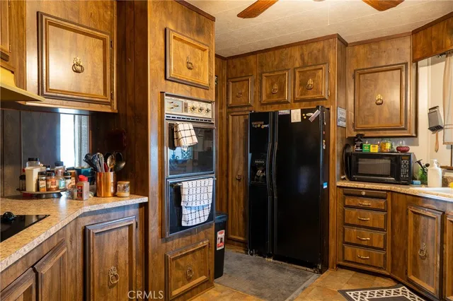 a kitchen with stainless steel appliances granite countertop a refrigerator and a stove