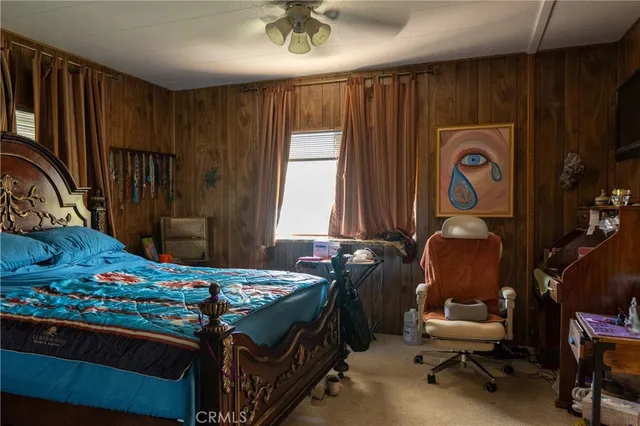 a bedroom with bed and a window