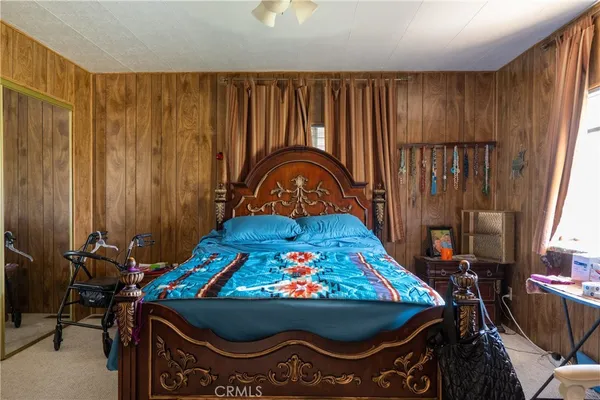 a bed sitting in a bedroom next to a window