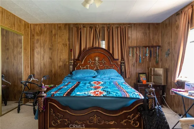 a bed sitting in a bedroom next to a window