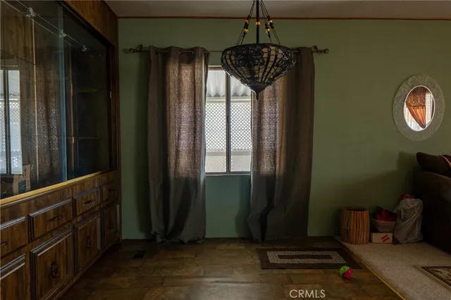 a view of a hallway with wooden floor and stairs