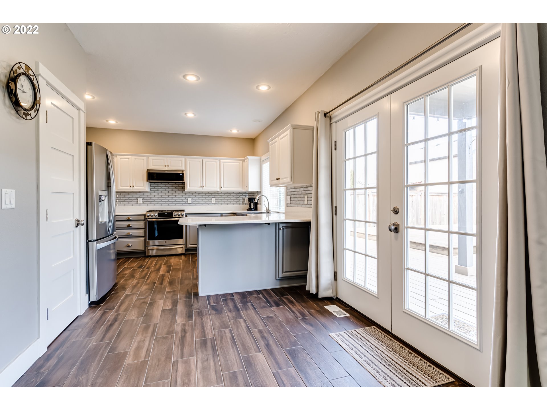 3370 Falcon Drive Springfield, OR 97477 - Photo 11 of 29 a kitchen with stainless steel appliances a refrigerator a sink dishwasher a stove and white countertops with wooden floor