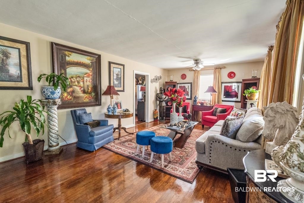 109 Esplanade Avenue Mobile, AL 36606 - Photo 8 of 45 Living area featuring wood finished floors and ceiling fan