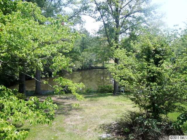 1147 Donnybrook Road Catawba, SC 29704 - Photo 13 of 16 a view of a yard with plants and large trees