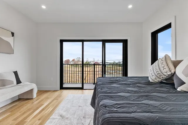 a bedroom with a large bed and a large window