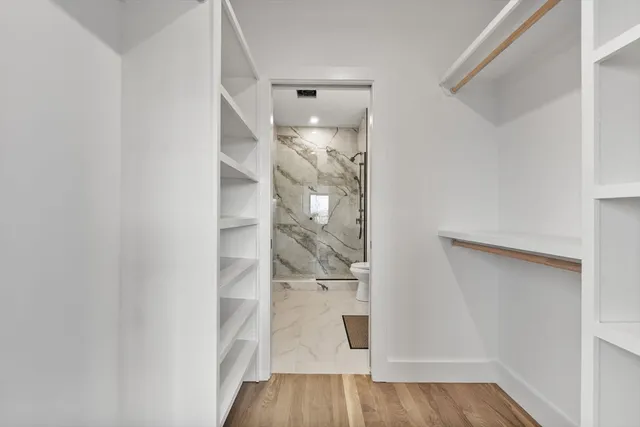 a view of a room with wooden floor