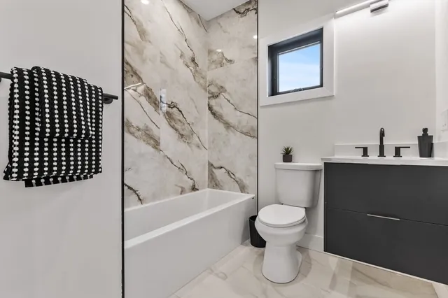 a bathroom with a toilet and a bathtub