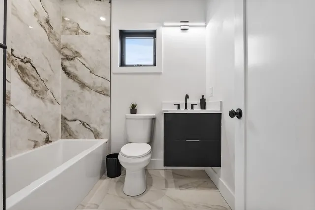 a bathroom with a sink a toilet and bathtub