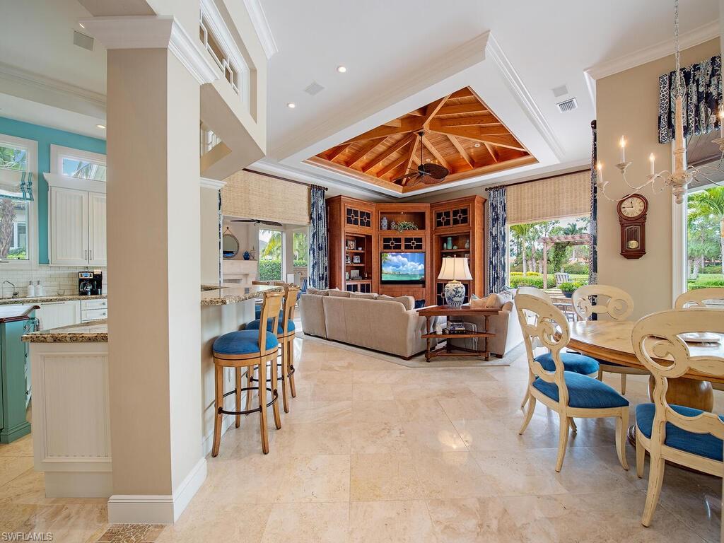 3123 Dahlia Way Naples, FL 34105 - Photo 11 of 29 a living room filled with furniture and a large window