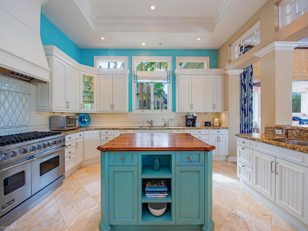 3123 Dahlia Way Naples, FL 34105 - Photo 13 of 29 a kitchen with stainless steel appliances granite countertop a stove a sink and a refrigerator