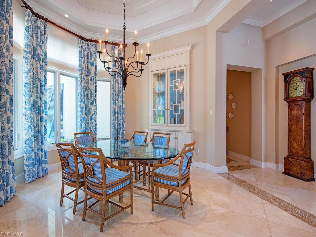 3123 Dahlia Way Naples, FL 34105 - Photo 15 of 29 a view of a dining room with furniture and chandelier