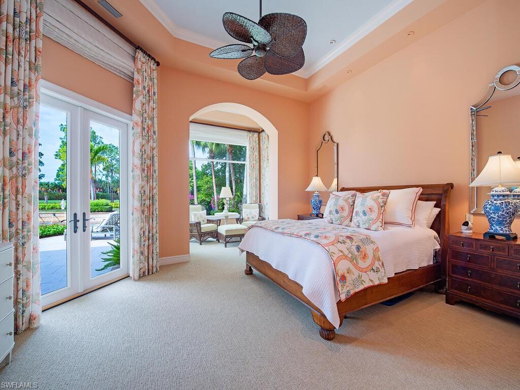 3123 Dahlia Way Naples, FL 34105 - Photo 18 of 29 a bedroom with a bed ceiling fan and a large window