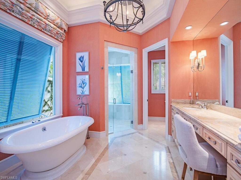 3123 Dahlia Way Naples, FL 34105 - Photo 19 of 29 a spacious bathroom with a tub sink and mirror