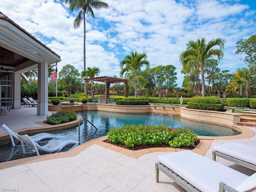 3123 Dahlia Way Naples, FL 34105 - Photo 2 of 29 a view of a swimming pool with a patio