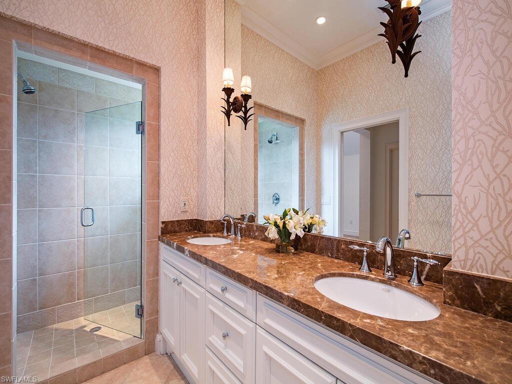 3123 Dahlia Way Naples, FL 34105 - Photo 23 of 29 a bathroom with a granite countertop double vanity and a mirror