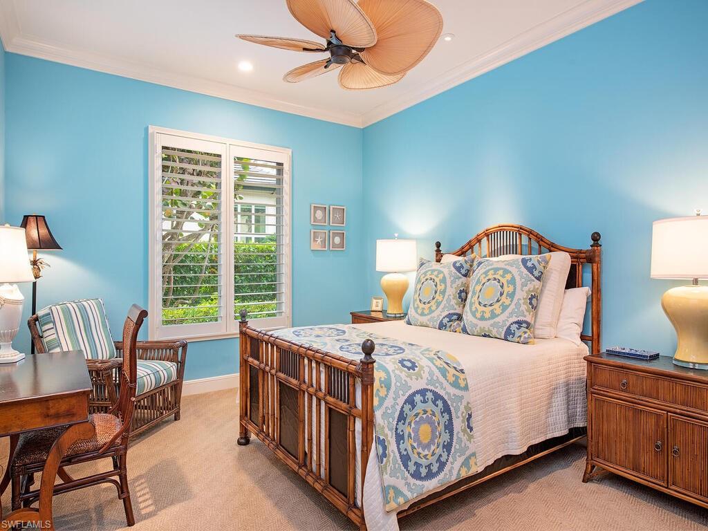 3123 Dahlia Way Naples, FL 34105 - Photo 24 of 29 a bedroom with a bed a table and chair