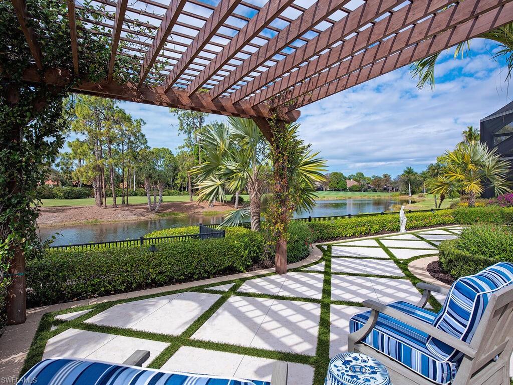 3123 Dahlia Way Naples, FL 34105 - Photo 3 of 29 a patio with yard table and chairs