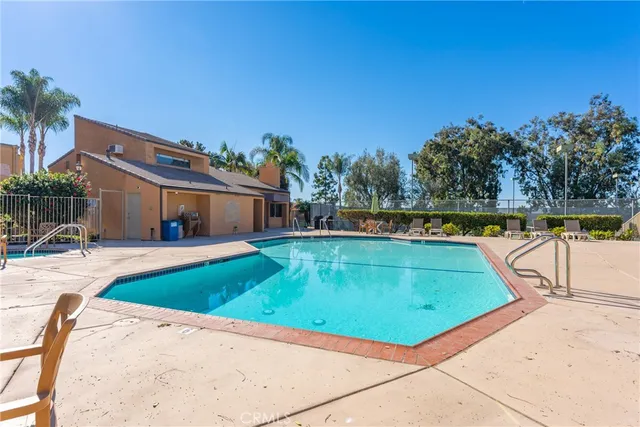 a view of a swimming pool with outdoor seating