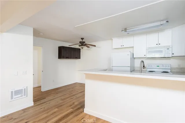 a kitchen with stainless steel appliances a sink stove and microwave