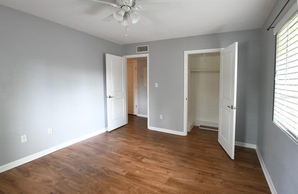 507 Northwest 39th Road, Unit 215 Gainesville, FL 32607 - Photo 12 of 21 wooden floor in an empty room with a window