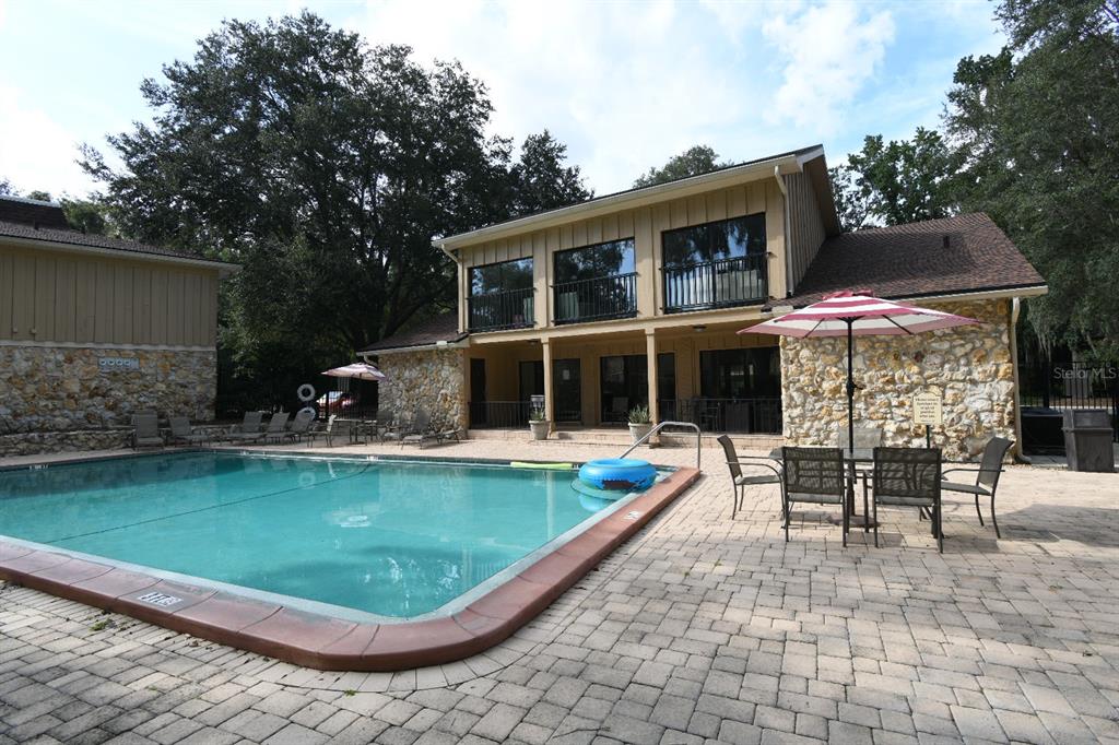 507 Northwest 39th Road, Unit 215 Gainesville, FL 32607 - Photo 16 of 21 a view of a swimming pool with a patio