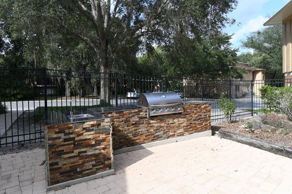 507 Northwest 39th Road, Unit 215 Gainesville, FL 32607 - Photo 18 of 21 a view of a bench with wooden fence