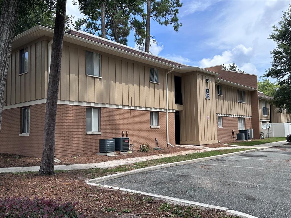507 Northwest 39th Road, Unit 215 Gainesville, FL 32607 - Photo 21 of 21 a front view of a house with a yard