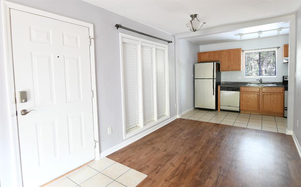 507 Northwest 39th Road, Unit 215 Gainesville, FL 32607 - Photo 4 of 21 a view of a kitchen with refrigerator and stove top oven