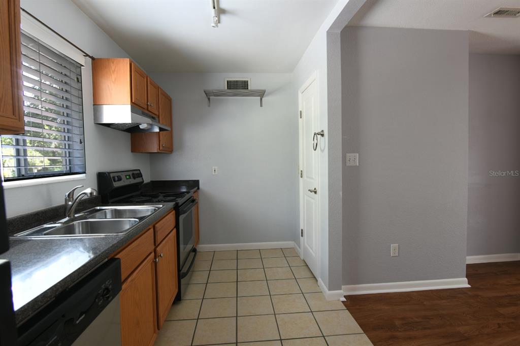 507 Northwest 39th Road, Unit 215 Gainesville, FL 32607 - Photo 7 of 21 a kitchen with a sink cabinets and a stove