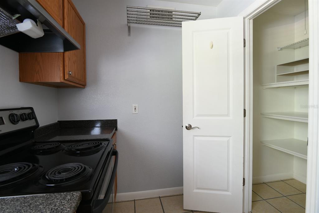 507 Northwest 39th Road, Unit 215 Gainesville, FL 32607 - Photo 8 of 21 a kitchen with a stove and a refrigerator